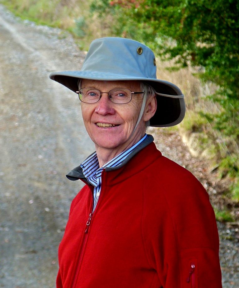 photo of phil gregory in blue hat and red sweater
